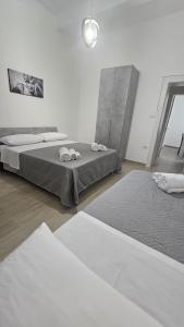 two beds in a white room with two mattresses at Casa Mia in Scilla