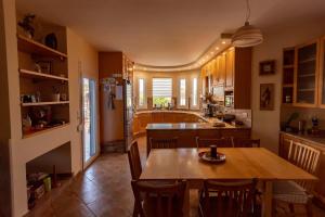 a kitchen and dining room with a table and chairs at Villa Sofia in Samos