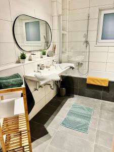 a bathroom with a sink and a mirror at HUMA Appartements in Söbriach