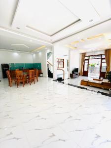 a living room with a large white tile floor at NHỚ House Đà Lạt V in Da Lat +39 photos