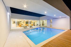 a swimming pool in the middle of a house at Smart Villa in Nerežišće