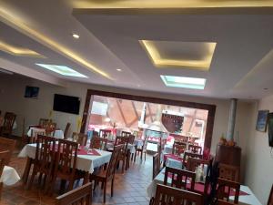 a dining room with tables and chairs in a restaurant at Hotel San Cristobal in San Cristóbal