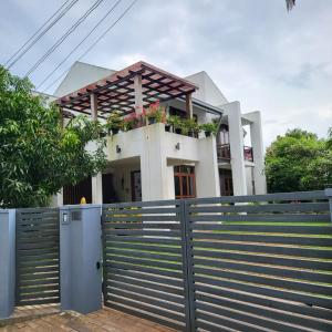 a house with a fence in front of it at Quin Villa in Katukurunda-Kalutara