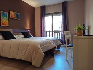 a bedroom with a large bed and a window at Hotel Marrodan in Arnedillo