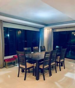 a dining room with a black table and chairs at SpittlerVilla in Talisay