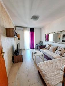 a living room with a couch and a table at Apartmani Cupic in Budva