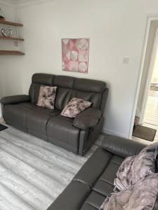 a leather couch in a living room with at Chatham Cozy House in Chatham