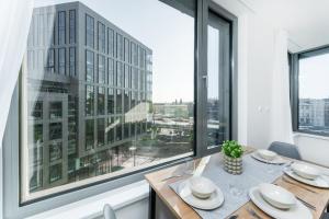 a dining room with a table and a large window at MyMozart apartments by Rentero property in Prague