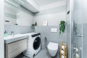 a washing machine in a bathroom with a sink at MyMozart apartments by Rentero property in Prague
