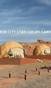 two domes in a desert with the words run city star luxury camp at Rum city Star LUXURY Camp in Wadi Rum