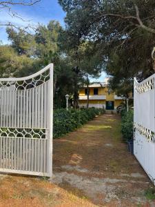 a pair of gates in front of a house at Villa Lu in Porto Cesareo