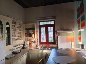 eine Küche mit einem Tisch und einem Fenster in der Unterkunft Mojo Art House 