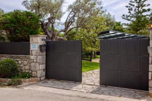 a pair of gates in a driveway at Poly's Villa Lefkada in Lefkada