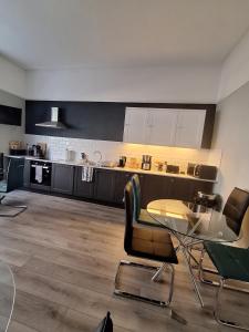 a kitchen with a table and chairs in a room at No 27 Chapel Street Guest House in Llandudno +18 photos