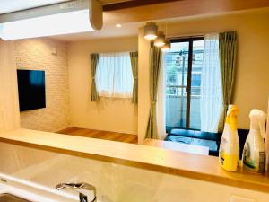 a bathroom with a sink and a mirror and a couch at MoRi House IN西日暮里Ⅱ in Tokyo +74 photos
