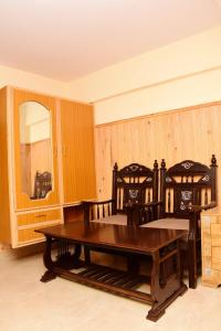a dining room with a table and chairs and a mirror at Quality Inn Hotel in Murree