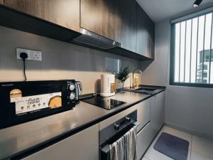 a kitchen with a counter top with a toaster oven at Datum Jelatek Residences Royalty Luxury Apartment, Walking Distance To LRT, Gleneagles KL & KLCC in Kampong Datok Keramat