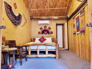 a room with a bed and a table and a wall at Mam Da Homstay in Na Hang +151 photos