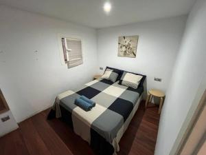 a bedroom with a bed in a white room at Centrally Apartment in El Raval in Barcelona