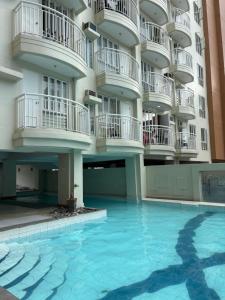 a swimming pool in front of a building at Tagaytay Staycation - Casa Editha in Tagaytay