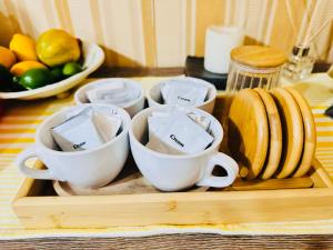 a tray with cups and plates on a table at Tagaytay Staycation - Casa Editha in Tagaytay