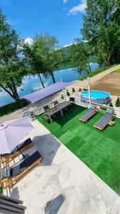 an overhead view of a pool with chairs and a lawn at Vikendica River Drina - Mali Zvornik-Velika Reka in Podrebelj