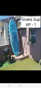 a blue surfboard on a stand in a room at Anita Prižba in Prizba