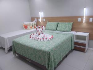Cama ou camas em um quarto em Pousada Beija Flor
