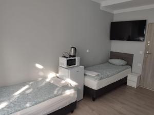 Cama o camas de una habitación en Pokoje hotelowe Wermar