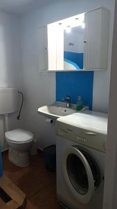 a bathroom with a washing machine and a sink at Smaragda home in Liaropá +37 photos