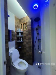 a bathroom with a toilet in a blue room at Oppas Studio Unit near Sm uptown in Cagayan de Oro