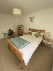 a bedroom with a large bed with white sheets and pillows at Torias Place - Lenham in Maidstone