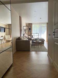 a living room with a couch and a table at AV apartamentai Palangoje in Palanga