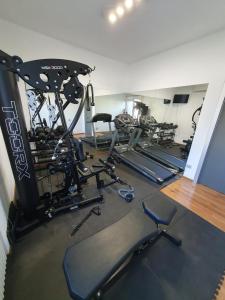 a gym with several tread machines in a room at B&B Cremonese in Parma