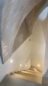 a stairway with a wooden ceiling and a stair case at Palazzo Salapolis - Luxury Apartments in Gallipoli +166 photos