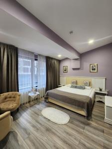 a bedroom with a large bed and a large window at Sport Point Hotel in Khimki