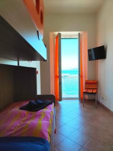 a bedroom with a bed and a view of the ocean at Arca di Noè casevacanzeargentario in Porto Santo Stefano