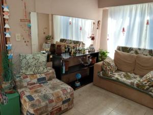 a living room with a couch and a chair at Norma in Tandil