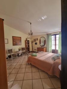 a bedroom with a large bed and a living room at Casa Anna Maria in Iglesias