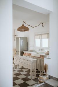 a kitchen with a sink and a table in a room at Yi & Thalassa Living by KHI in Kithnos