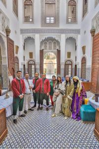 a group of people posing for a picture in a mosque at Riad Fes Ziyat & Spa in Fès