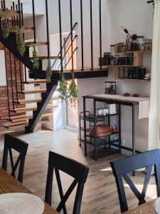 a living room with stairs and a table and chairs at Zielnisko in Firlej