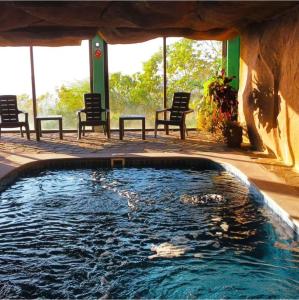 a large swimming pool with chairs and chairs in a building at Hostal bajo las estrellas in Chicá