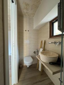 a bathroom with a sink and a toilet at Le Casette di Ciccio in Fasano +14 photos