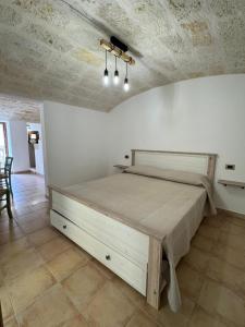 a bedroom with a large bed in a room at Le Casette di Ciccio in Fasano