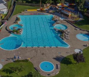 an overhead view of a large swimming pool at Pension Felseneck in San Leonardo in Passiria
