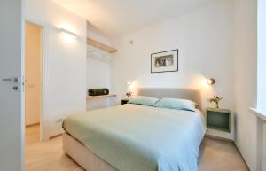 een slaapkamer met een groot bed in een witte kamer bij SISTERS' HOUSE in Varenna