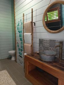 W łazience znajduje się umywalka i lustro. w obiekcie TIKI PARADISE LODGE FWI w mieście Sainte-Anne