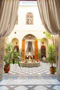 a large courtyard with plants in a building at Riad Al Ansari in Fez
