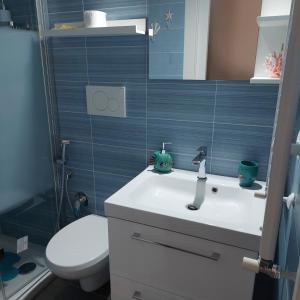 a bathroom with a white sink and a toilet at Dimora Kalypso in Polignano a Mare